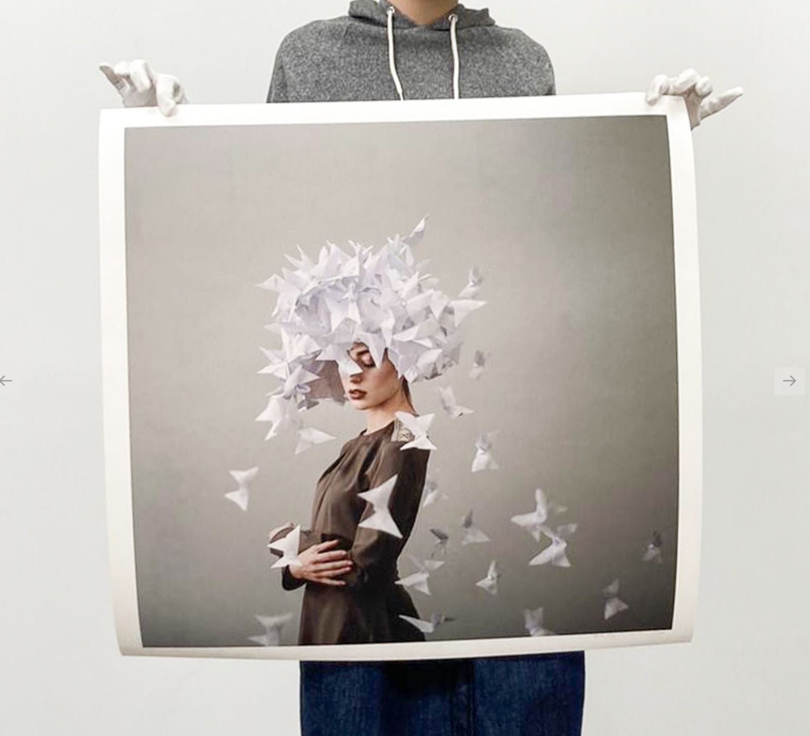 Paper butterflies ascend around a quiet figure in soft, surreal tones.