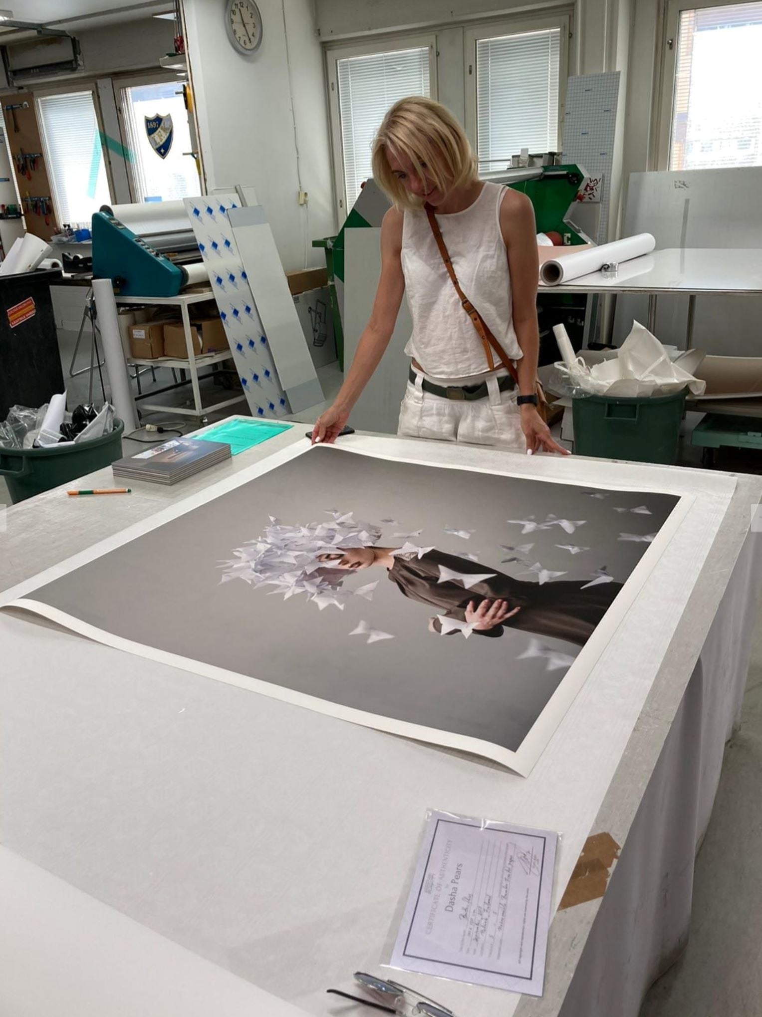 Paper butterflies ascend around a quiet figure in soft, surreal tones.